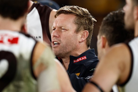 Sam Mitchell addresses his players during the clash with the Saints at Marvel Stadium.