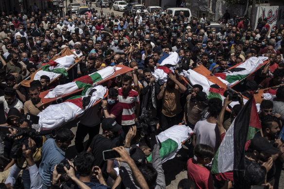 Palestinians attend the funeral of two women and eight children of the Abu Hatab family in Gaza City, who were killed by an Israeli air strike.