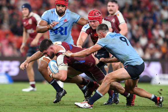 Liam Wright is tackled of the Reds