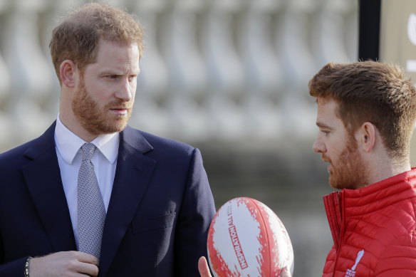 Britain's Prince Harry listens to Rugby League World Cup 2021 ambassador James Simpson.