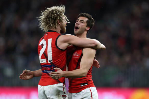 Kyle Langford of the Bombers celebrates a goal with Dyson Heppell.