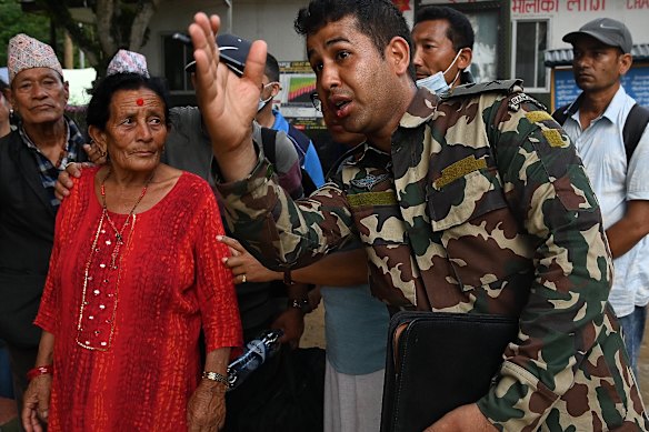 Nepalese soldiers give directions to local residents, thousands of whom have been left homeless.