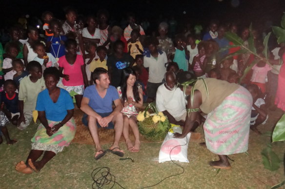 Kawai Yeung and David Kaunitz at their custom wedding on Rannonga Island, in the Solomons, in 2013. The bag of rice on the ground is a dowry.