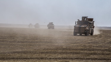 Turkish and Russian patrol is seen near the town of Darbasiyah, Syria, on Friday.
