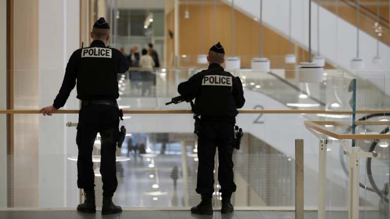 French Police officers look on during a break on the last day of UBS bank's trial at the Paris courthouse this week.