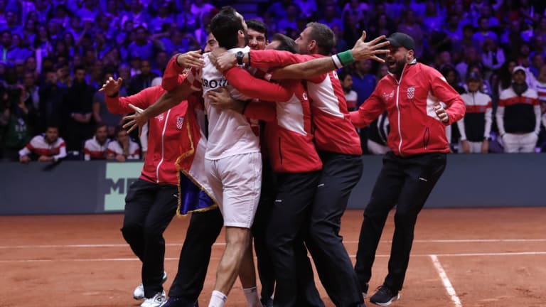 Marin Cilic is mobbed by his teammates after victory ensured the Davis Cup was theirs.