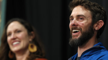 Runner Travis Kauffman, accompanied by his girlfriend Annie Bierbower, answers reporters' questions about his encounter with a mountain lion.