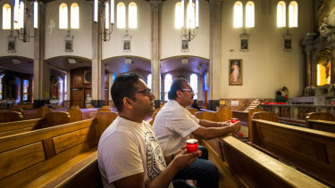 Muslim and Buddhist friends mourn Alexendria and Manik at the Catholic church the family once visited every week.