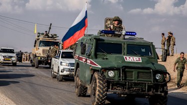 Kurdish forces withdraw from from an area near Turkish border with Syria, overseen by the Russian forces.