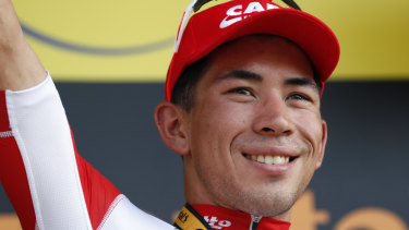 Australia's Caleb Ewan celebrates on the podium after he won the Tour de France's 16th stage. 