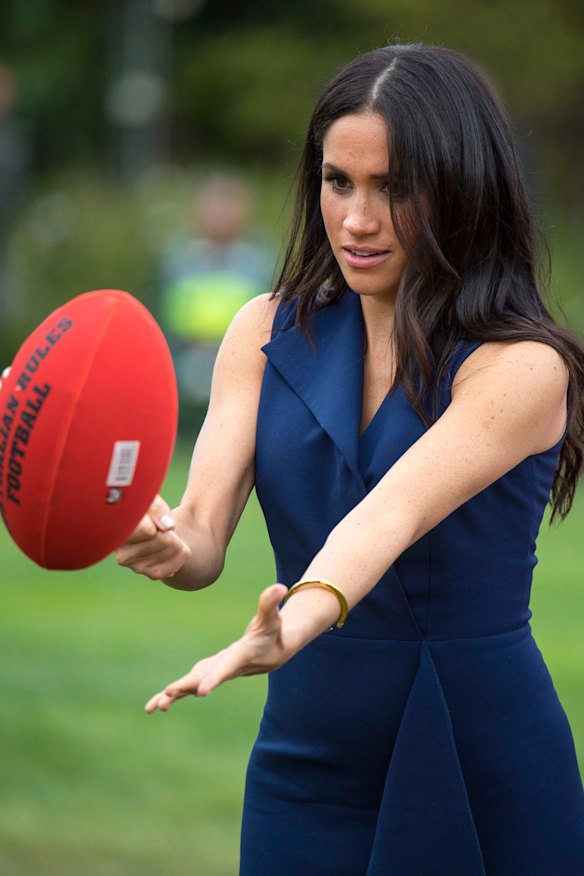 The Duchess of Sussex had a crack at handballing during her trip to Australia in 2018.