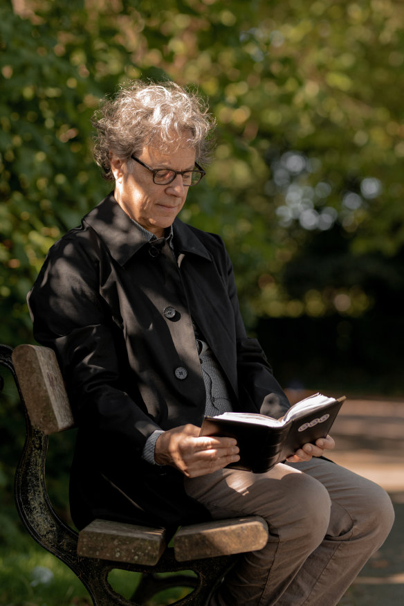 Ian Russell with a photo album of his daughter Molly Russell, near his home in Harrow, in north-west London.