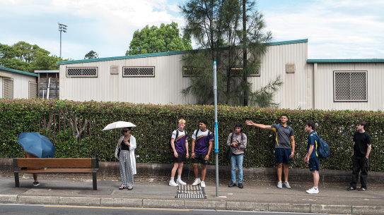 Commuters at a bus stop on Parramatta Road in Camperdown.