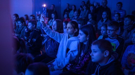 Children watch a St Nicholas Day performance in a basement in Kharkiv, Ukraine, on the weekend. In this area near the Russian border, children study online, have to spend significant time in shelters, and suffer from the stress of daily air raid alerts.