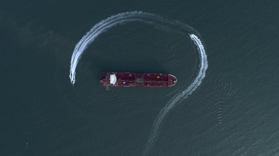 Aerial view of an Iranian Revolutionary Guard speedboat moving around a British oil tanker in the Strait of Hormuz on July 21.