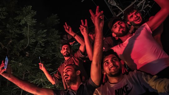 Palestinians celebrate the cease-fire agreement between Israel and Hamas on May 21, 2021 in Gaza City, Gaza. 