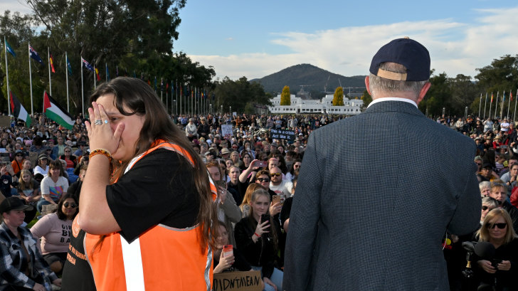 Rally organiser Sarah Williams looks away as Prime Minister Anthony Albanese speaks at the event calling for an end to violence against women, in Canberra yesterday.