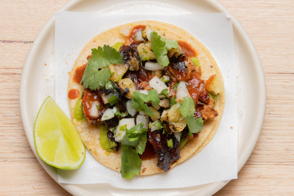 Pork al pastor taco, featuring pork off the spit and pineapple salsa.
