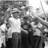 Director Peter Weir gives a lead to hit extras during rehearsals for the spectacular demonstration scene.
