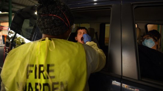 Owen, 7, reacts to a COVID-19 test.