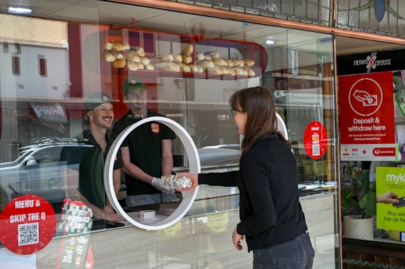 Sandwiches are passed through the porthole window.