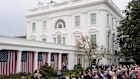 President Donald Trump signs an executive order during an event to announce new tariffs in the Rose Garden of the White House.