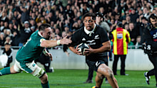 New Zealand’s Anton Lienert-Brown breaks a tackle from Ireland to score a try.