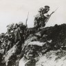 Australian infantrymen clamber over the top of a trench on the Western Front, in France, on a bayonet charge towards the German lines.