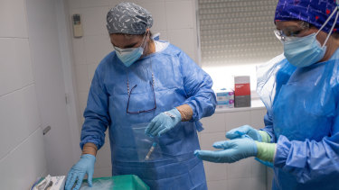 Health workers in Spain prepare to treat coronavirus patients.