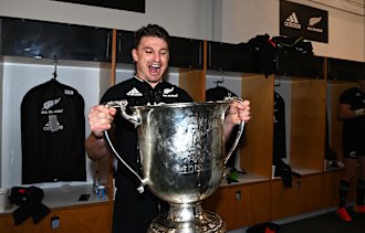 Beauden Barrett gets his hands on the Bledisoe Cup.