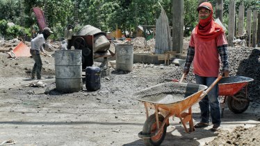 Amrulah working at a construction site in his village of Nipah in north Lombok.