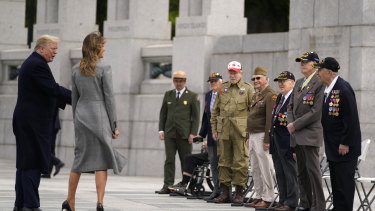 Veterans talk with President Donald Trump and first lady Melania Trump during a ceremony at the World War II Memorial to commemorate the 75th anniversary of Victory in Europe Day.