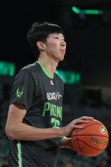 Zhou Qi warms up prior to the round two NBL game between South East Melbourne Phoenix and New Zealand Breakers at John Cain Arena.