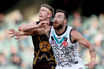 Eyes on the ball: Charlie Dixon, right, in action against the Hawks in round 13. 