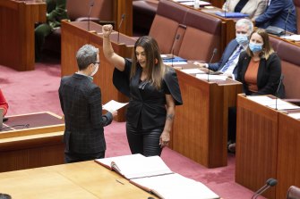Greens Senator Lidia Thorpe makes a defiant gesture as she is sworn into office at Parliament House on Monday.