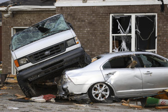A car wrecked by a tornado sits on top of another car in Bowling Green, Kentucky.