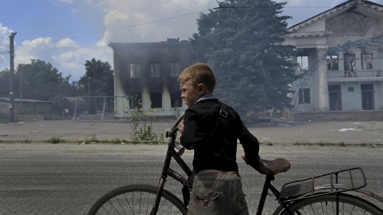 The two boys have the smudged faces of children who never get to have a bath. 