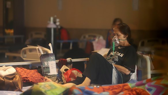 A COVID-19 patient rests on a bed at a makeshift hospital in Delhi.