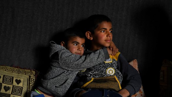 Anas Azad, 4, hugs his nine-year-old brother, Ayham Azad, at their home in Sharya village, Iraq. The boys were were kidnapped by IS and forced to live with them.