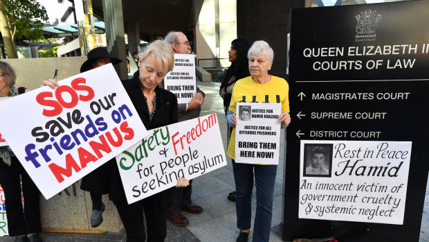 Protester Jillian Oldfield (left) from the Refugee Action Collective is seen during a vigil for deceased asylum seeker Hamid Khazaei outside the Brisbane Magistrates Court.