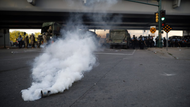 Police deploy tear gas against demonstrators on Friday, local time, in Minneapolis. 