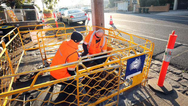 NBN workers lay the cable as the roll-out nears its final stage.