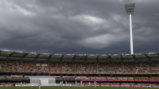 Rain clouds gather over play on day two of the fourth Test between India and Australia at the Gabba on Saturday.