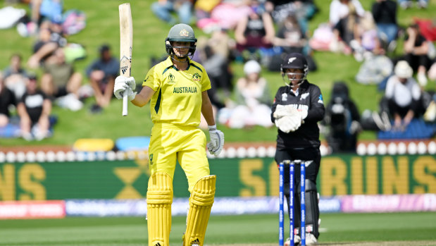 Ellyse Perry raises her bat after reaching her half century at the Basin Reserve.