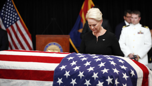 Cindy McCain, wife of Senator John McCain, looks at the casket during a memorial service at the Arizona Capitol.