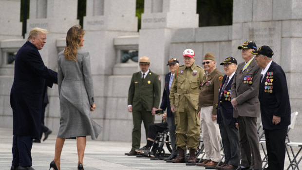 Veterans talk with President Donald Trump and first lady Melania Trump during a ceremony at the World War II Memorial to commemorate the 75th anniversary of Victory in Europe Day.