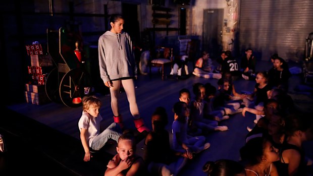 Venezuelan Paola Nava, 17, who with her parents are hoping to migrate, helps younger dancers backstage in Florida.