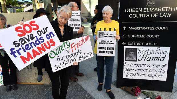 Protester Jillian Oldfield (left) from the Refugee Action Collective is seen during a vigil for deceased asylum seeker Hamid Khazaei outside the Brisbane Magistrates Court in Brisbane on Monday.