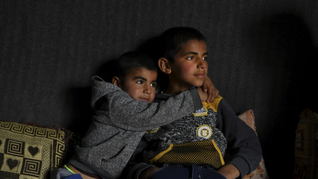 Anas Azad, 4, hugs his nine-year-old brother, Ayham Azad, at their home in Sharya village, Iraq. The boys were were kidnapped by IS and forced to live with them.