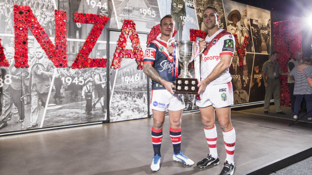 Spirit: Roosters' Jake Friend and Dragons' Jason Nightingale hold the trophy that honours the memory of the Anzacs.